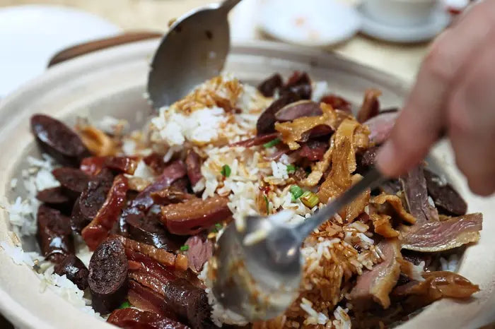 Fragrant Claypot Rice with Preserved Waxed Meat, prepared using the winter cooking style, where the meat is served separately from the rice and then mixed at the table. — Photos: GLENN GUAN/The Star