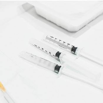 syringes lined up on a medical tray