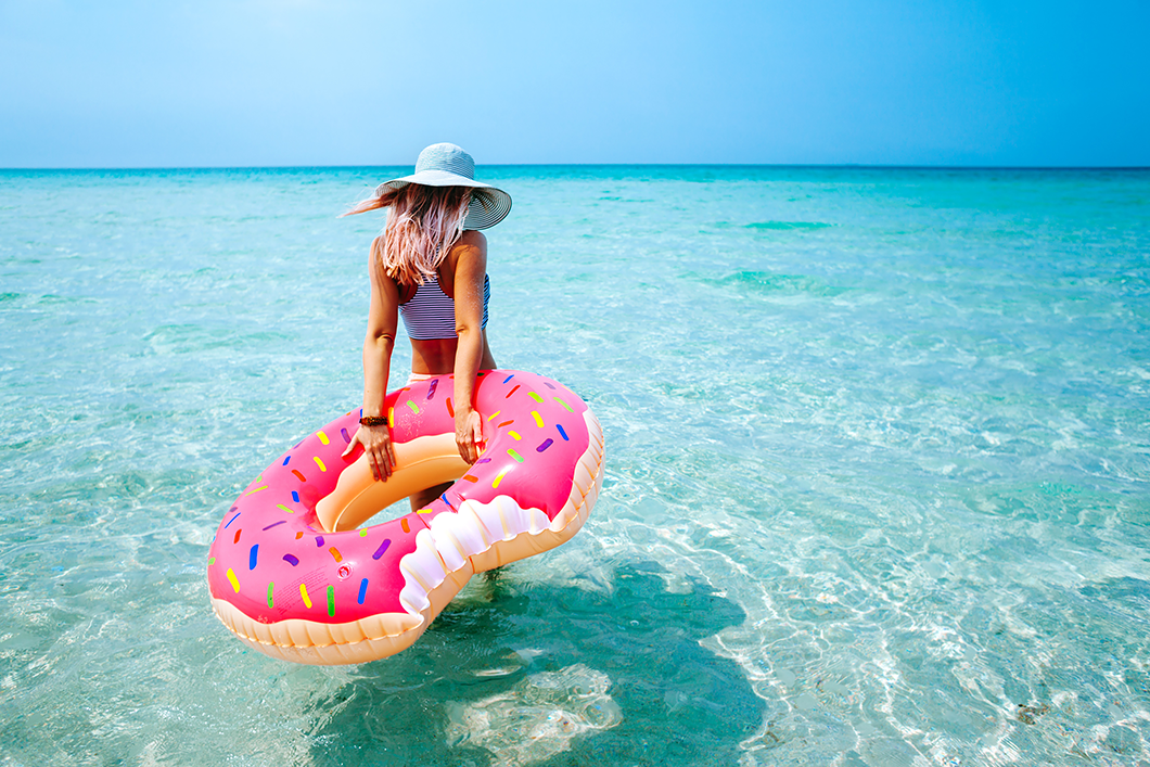 confident girl on the beach after full bikini waxing in Orlando