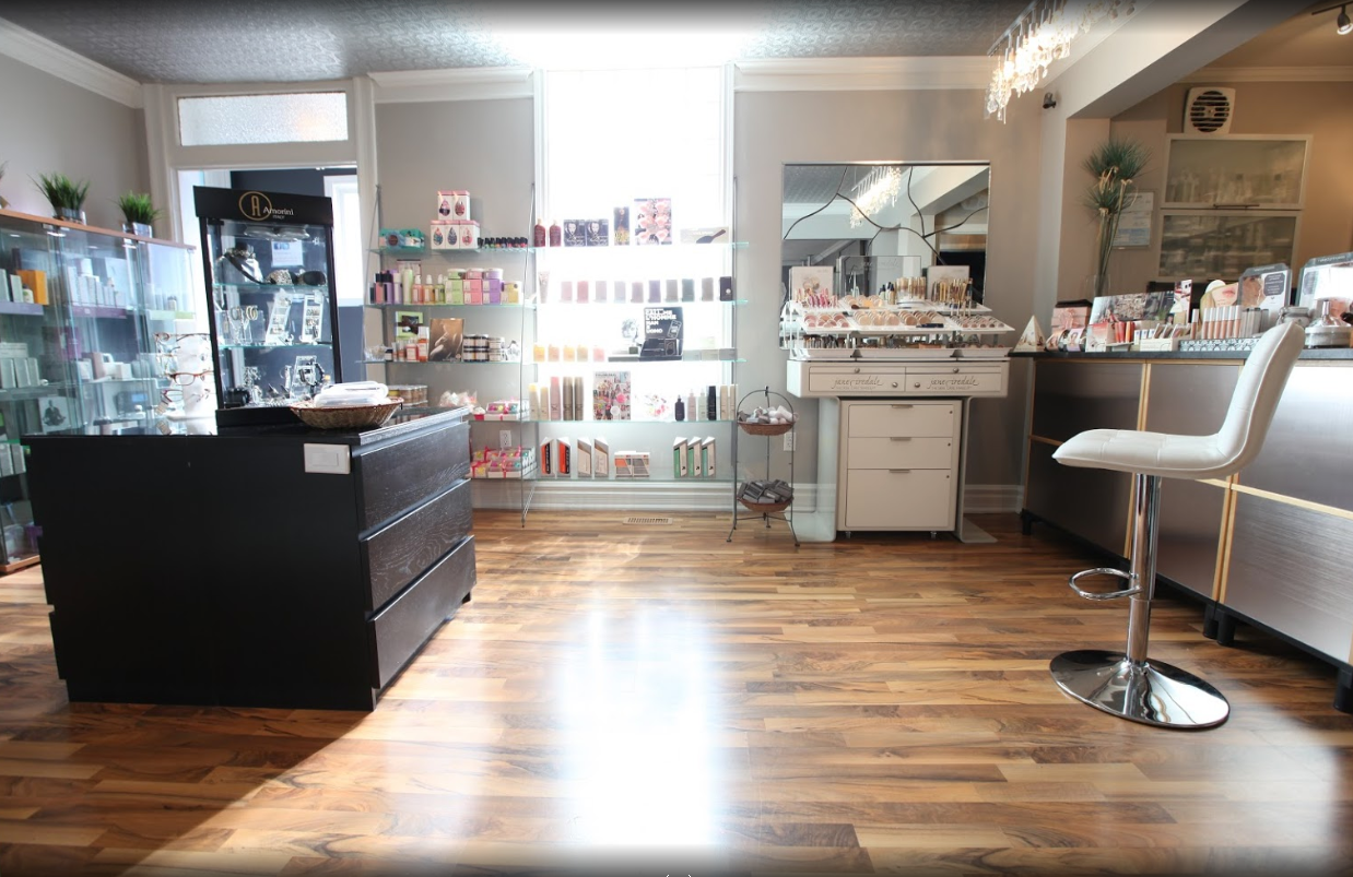 Interior of a spa with various shelves filled with nail polish, facial cleansers and other skin products