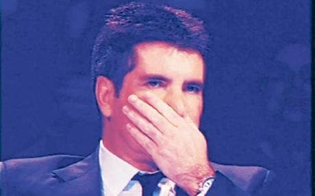 Simon Cowell reveals his waxed hand during 'The X Factor' Credit: Photo: Images International Limited/ITV