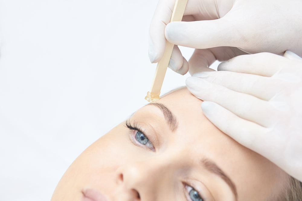 woman getting wax treatment