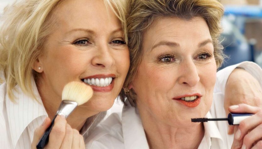 This image shows two ladies over 55 with make up brushes. One has blonde hair the other brown and for their ages they look pretty good!