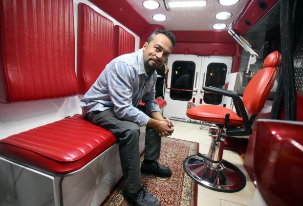 Jesus Bujanda sits in the back of his mobile tattoo removal unit on Tuesday in Greeley. Bujanda, based out of Denver, has been using the unit to help prisoners remove gang tattoos and is hoping to expand the business further within the coming year.