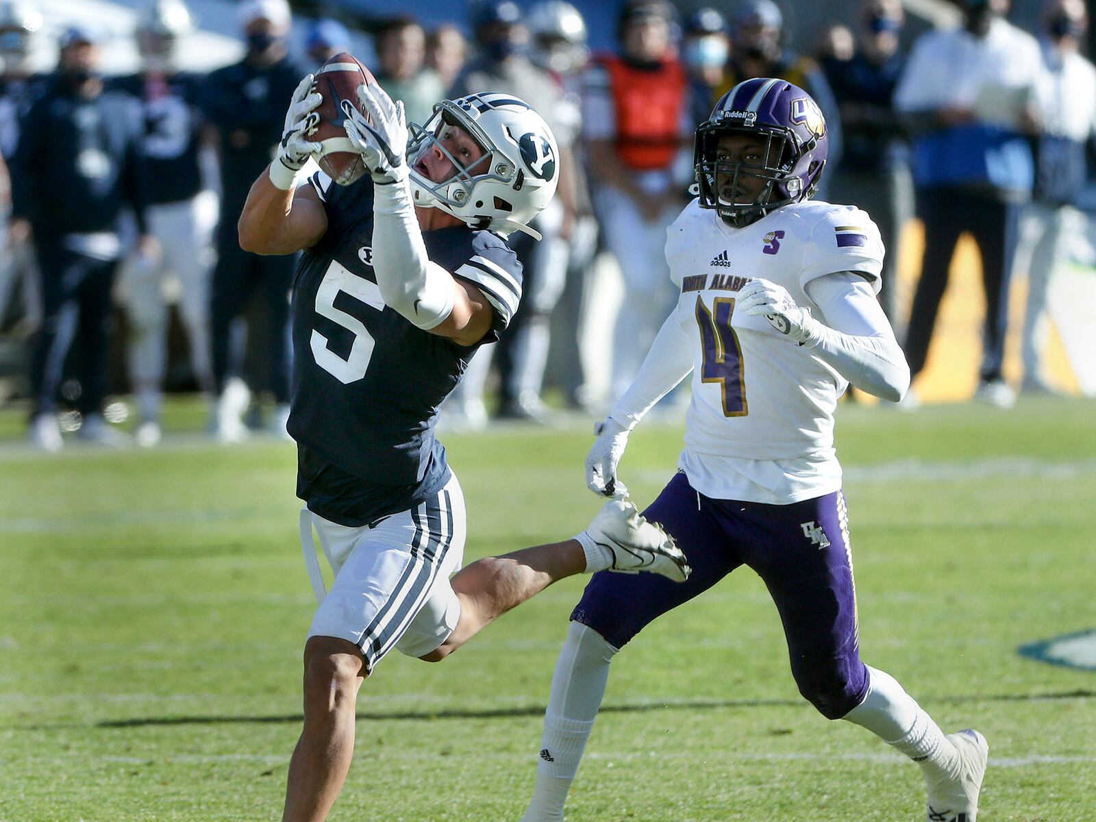 Brigham Young Cougars wide receiver Dax Milne (5) hauls in a long pass over North Alabama Lions cornerback Will Singleton (4) during a game in Provo on Saturday, Nov. 21, 2020.