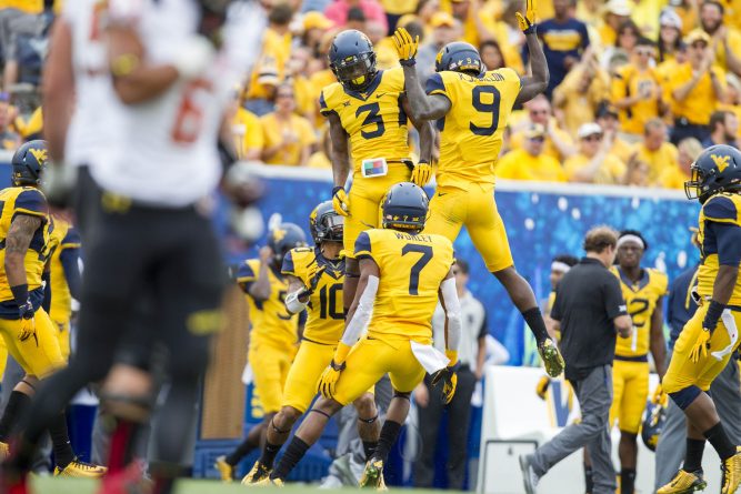 West Virginia cornerback Rick Rumph III (3) and safety KJ Dillon (9) celebrate an interception during the 45-6 win over Maryland.