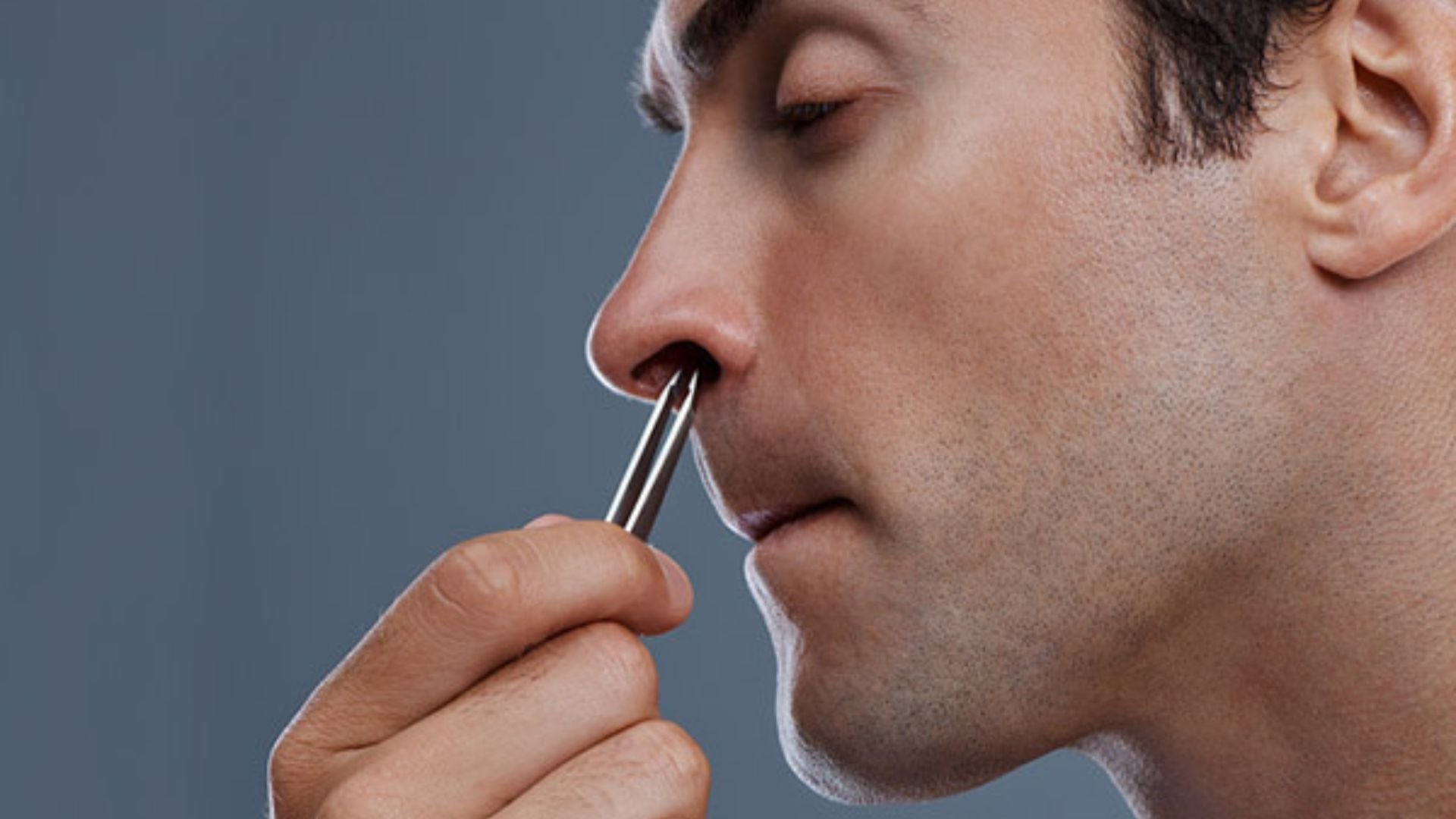 man shaving his nose