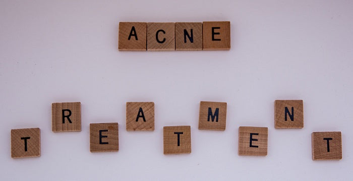 the words acne treatment made of scrabble pieces