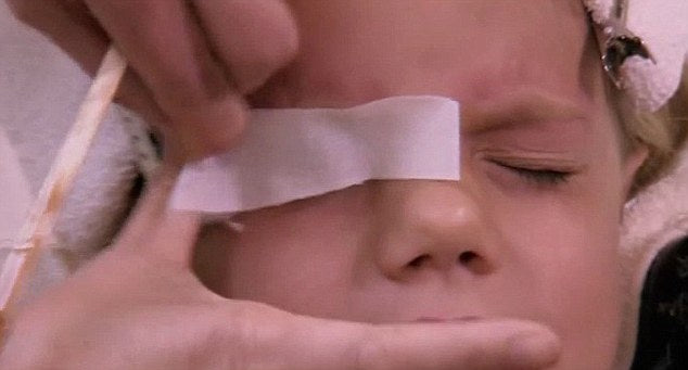 Stinging: Nine-year-old Chloe screws up her face as a beautician prepares to wax her eyebrows