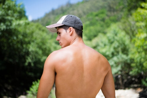 man with hairless back looking to side