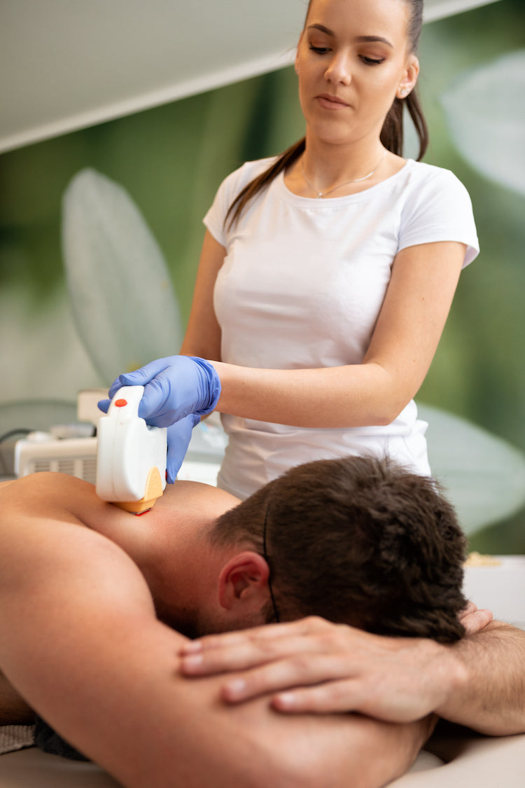 Man undergoing laser hair removal treatment