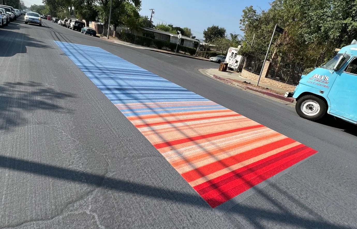 One of the art pieces symbolizing a heat scale near Hubert H. Humphrey Park in Pacoima, where 10 square blocks, a basketball court and elementary school yard have been coated with "cool paint." The whole street in this image is coated with the paint.